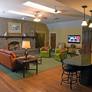 A cozy living room with a fireplace, television, and comfortable seating.