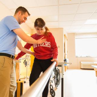 A physical therapist assists a patient in rehabilitating through guided exercises.