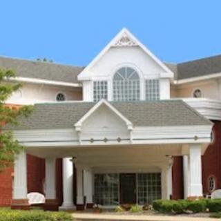 A building entrance with a gabled roof and columns.