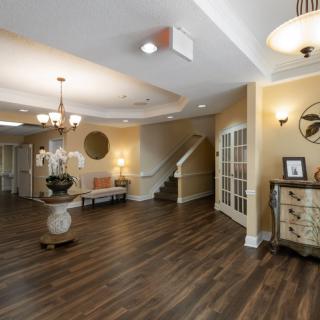 A spacious lobby area with elegant decor and a central staircase.