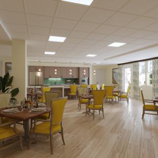 A bright and spacious dining area with yellow chairs, wooden floors, and large windows.