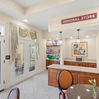 A cozy interior of a general store featuring a counter, seating area, and decorative elements.