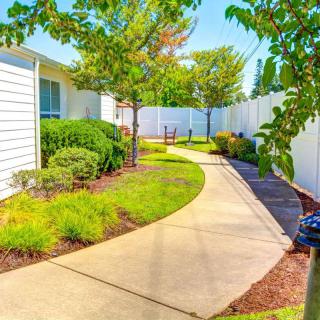 A beautifully landscaped garden with a winding pathway and lush greenery.