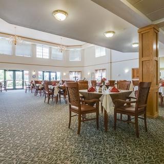 An empty dining area with neatly arranged tables and chairs.
