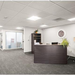 A modern office reception area featuring sleek furniture and a welcoming atmosphere.