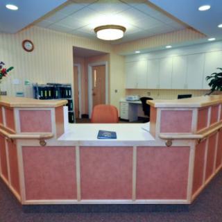 A spacious reception area with a central desk and office furnishings.