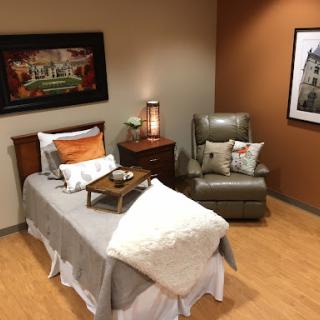 A cozy and well-decorated bedroom featuring a comfortable bed and inviting seating area.