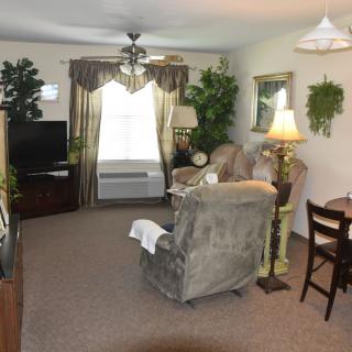 A cozy living room with comfortable seating and warm lighting.