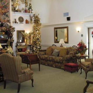 A traditionally styled living room with cozy seating and elegant decor.