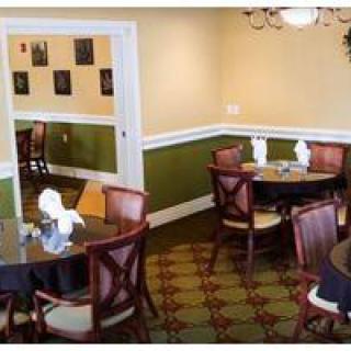 An elegant restaurant dining area with neatly arranged tables and chairs.