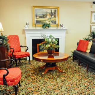 A classic living room with elegant furniture and a cozy fireplace.