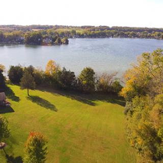 A serene autumn landscape overlooking a tranquil lake.
