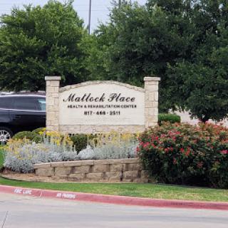 Entrance sign of Mattlock Place, a residential community surrounded by greenery.