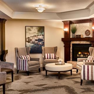 A cozy living room featuring stylish armchairs and a fireplace.