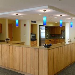 A modern reception area with wood paneling and soft lighting.