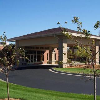 A modern building with a covered entrance and well-maintained landscaping.
