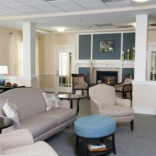 A cozy living room with sofas, a coffee table, and a fireplace.