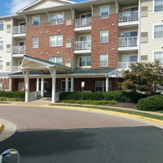 A residential apartment building with modern architecture and well-maintained landscaping.