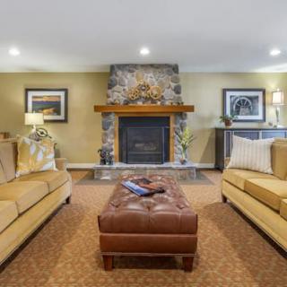 A cozy living room featuring a central fireplace and comfortable seating.