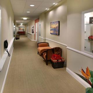A well-decorated hallway with seating and artwork on the walls.