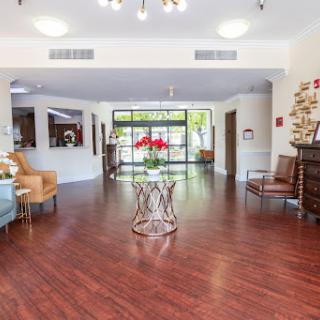 A spacious and inviting lobby featuring modern seating and hardwood flooring, perfect for welcoming guests.