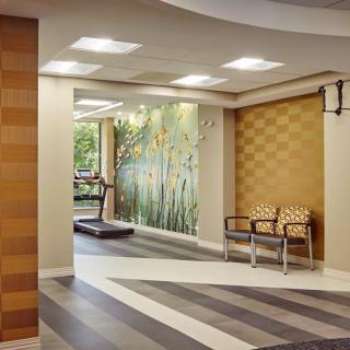 A modern lobby with decorative wall art, comfortable seating, and ample indoor lighting.