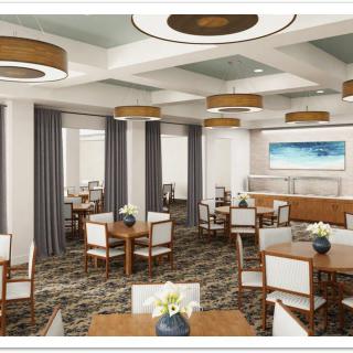 A well-appointed dining area featuring multiple tables and chairs, elegant lighting, and stylish decor.
