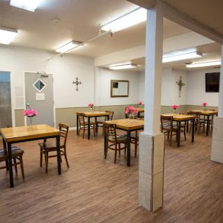 A spacious dining area featuring wooden tables and chairs, designed for casual gatherings.