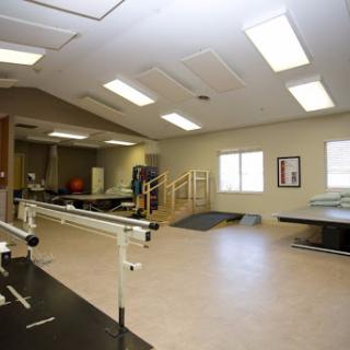An interior view of a rehabilitation therapy room designed for physical therapy and exercise.