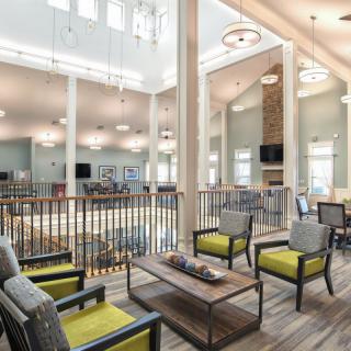 A spacious and modern lounge area with comfortable seating and bright lighting.