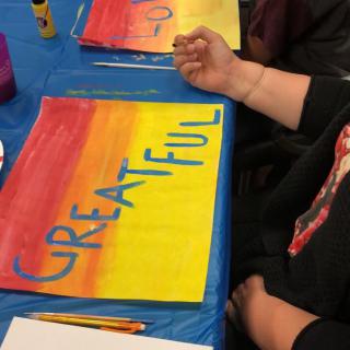 A colorful art piece featuring the word 'GREATFUL' created during a painting workshop.