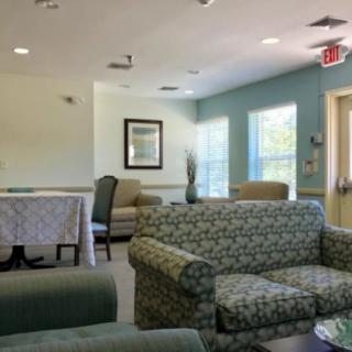A cozy and well-lit waiting area with sofas and chairs.