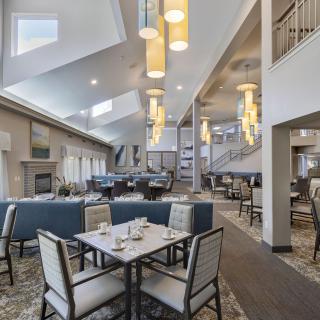 A modern and spacious dining area with elegant lighting and comfortable seating.