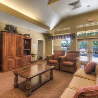 A cozy living room with comfortable seating and wooden furnishings.