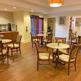 A cozy indoor cafe with wooden floors and comfortable seating arrangements.