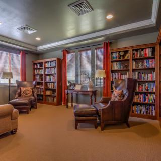 A cozy library with bookshelves and comfortable armchairs, perfect for reading.