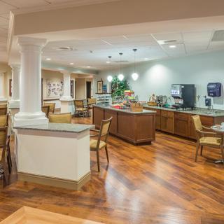 A modern cafe interior with wooden floors and seating area.