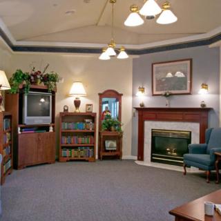 A cozy living room with a fireplace, TV, and comfortable seating.