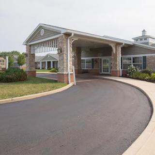 A welcoming entrance to a modern residential building with landscaped surroundings.