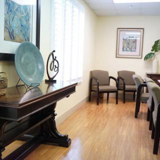 A serene waiting room featuring elegant furniture and decorative art.