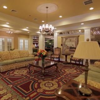 A traditional living room with elegant furnishings and a chandelier.
