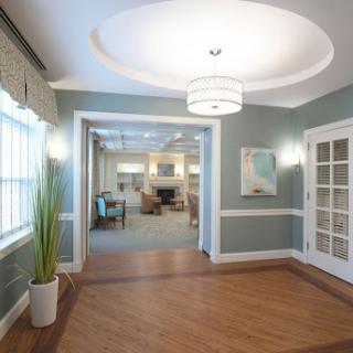 A modern lobby featuring stylish design elements, including a unique ceiling light and a spacious layout.