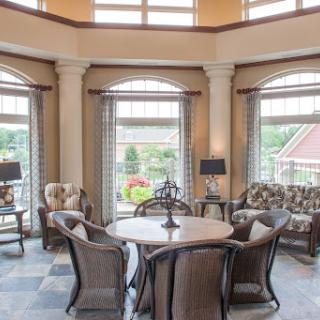 A cozy and elegant living space filled with natural light, featuring stylish furniture and a welcoming atmosphere.