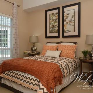 A cozy bedroom with patterned bedding and stylish decor accents.