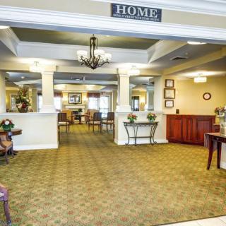A welcoming lobby area with elegant decor and a chandelier.