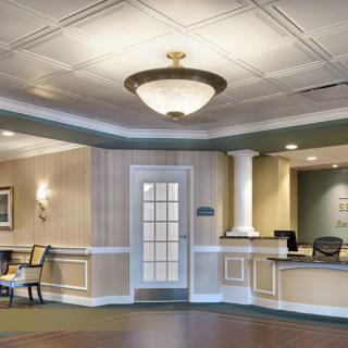 A well-decorated lobby area with a reception desk and seating.