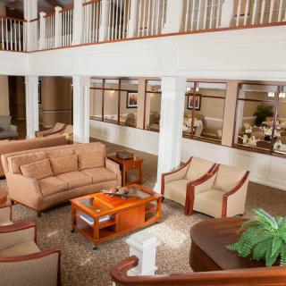 A spacious and well-decorated lobby with comfortable seating arrangements and a central coffee table.