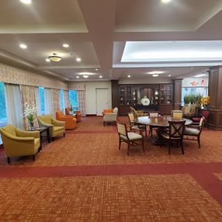 A spacious and elegant lounge area featuring comfortable seating and a warm color palette.