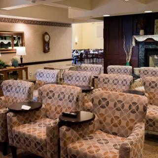 A cozy seating area with patterned chairs arranged in rows, ideal for a lobby or waiting room setting.
