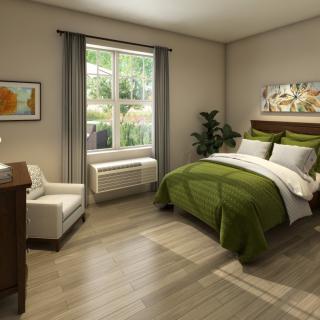 A modern bedroom featuring green bedding, a large window with natural light, and stylish decor.